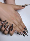 Alluring matte black ombre press on nails with sparkling rhinestone accents, featuring a sultry gradient finish. Perfect for parties, dates, holidays and special occasions. Long length stiletto shape fake nails with a bold, glamorous look.