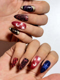 Magical celestial press on nails with star and moon motifs, elegant swan patterns, and rich mixed jewel tones with gold foil accents. Perfect for holiday parties, dates and special occasions. Medium length almond shape fake nails with a whimsical, enchanted finish.