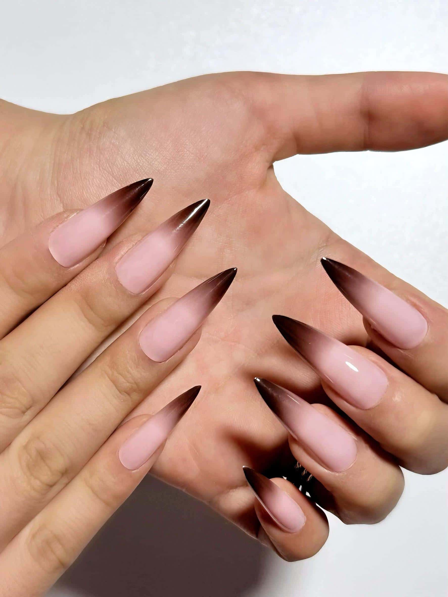 Nude pink brown ombre French tip press on nails, long stiletto cat claw shape for holiday and special occasions. Elegant gradient fake nails with a sleek, pointed finish.