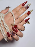 Bold red press on nails adorned with huge rhinestones, 3D rose charms, ribbon accents and polka dot details. Perfect for parties, dates and daily use. Long almond shape fake nails with a glamorous, romantic finish.