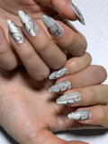 Swirl silver line white cat eye press on nails with a shimmery finish. Perfect for daily use, office, parties and holidays. Medium length almond shape fake nails with a sleek, futuristic vibe.
